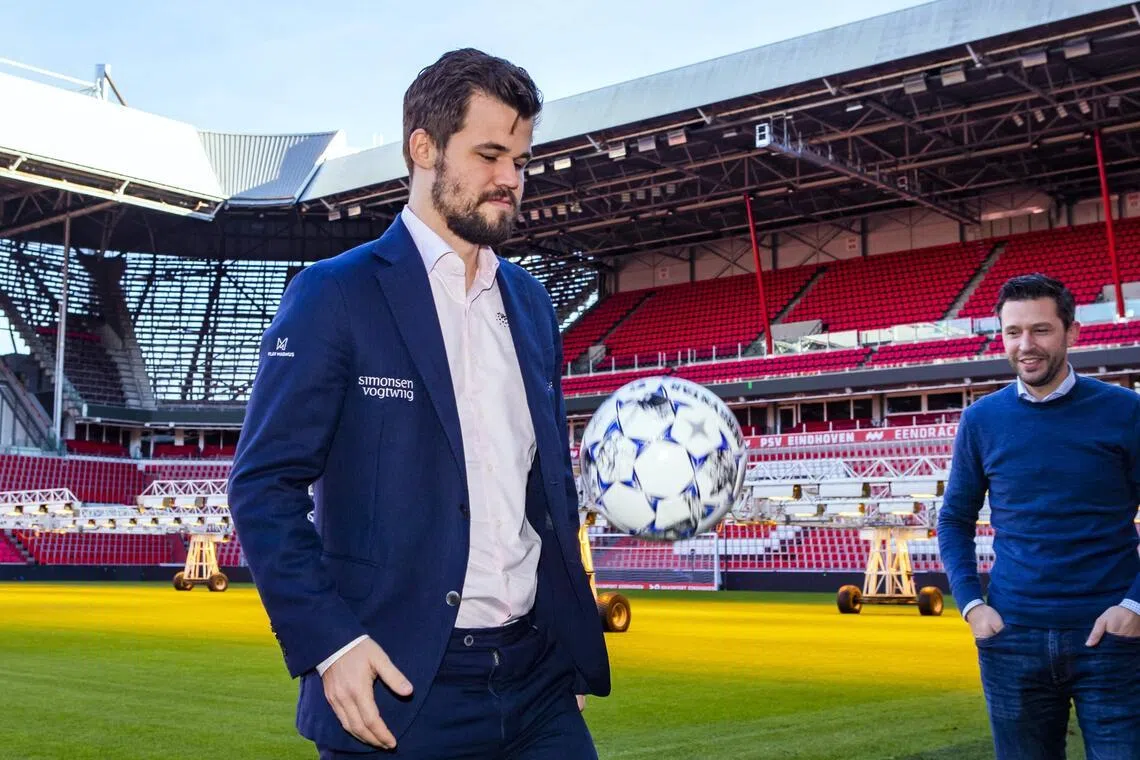 挪威棋王卡尔森（左）是忠实的足球迷，在象棋比赛前也不忘到足球场上颠两下球。（法新社档案照片）